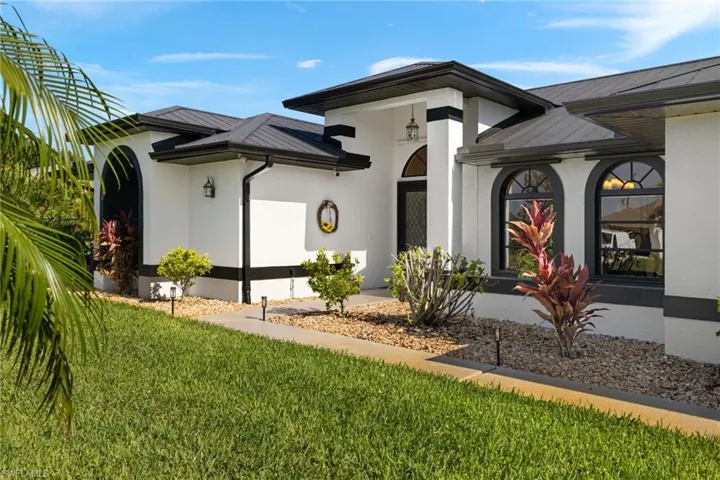 Entrance to property featuring a lawn