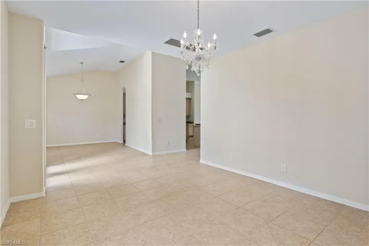 Spacious open-concept living and dining area filled with natural light. Features tile flooring, neutral tones, and plenty of room for entertaining or family gatherings in a comfortable, elegant setting.