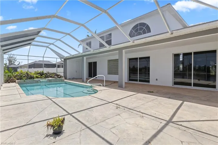 A spacious screened lanai with ample room for lounging and dining, perfect for enjoying Florida's year-round sunshine.
