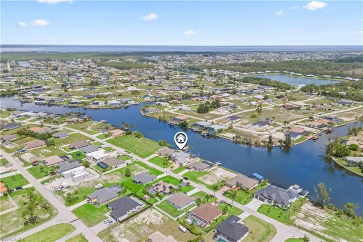 Community-wide aerial view showing the home’s location within a scenic, canal-front neighborhood—perfect for boating, relaxation, and Florida living.