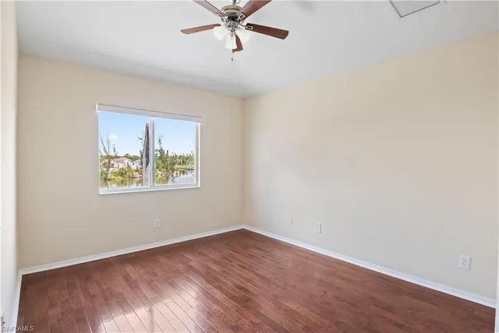 Well-appointed guest bedroom with plenty of space and natural light, conveniently located near a full bathroom.