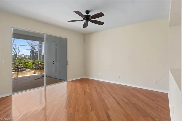 Elegant primary bedroom boasting a sliding glass door to the pool and canal area, providing stunning views and effortless connection to the outdoors.