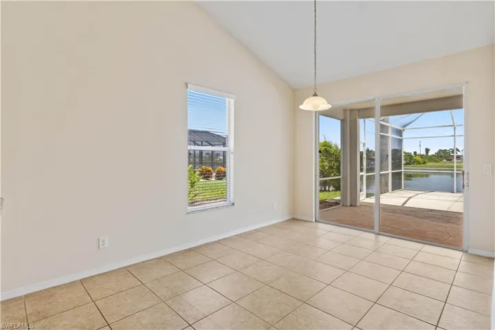 Charming eat-in area bathed in natural light, offering peaceful views of the pool and canal. A perfect spot for casual meals while enjoying the serene waterfront setting.