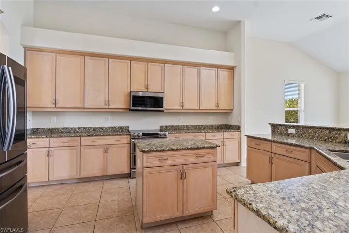 Generous cabinet space throughout the kitchen provides plenty of room to store cookware, dishes, and pantry essentials, keeping the area organized and clutter-free.