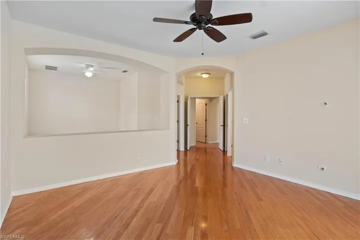 Bright and airy primary suite complete with a comfortable sitting area, enhancing the room’s functionality and comfort.