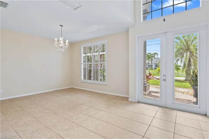 Bright and open main living room with high ceilings and tile flooring, perfect for entertaining.
