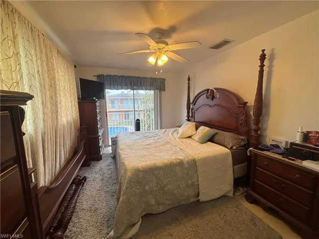 Bedroom with access to exterior and a ceiling fan