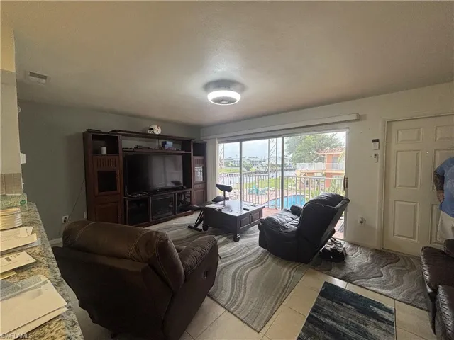 Living area with light tile patterned floors