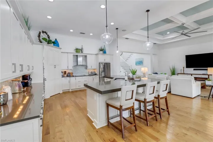 Seating for 6 around the large quartz countertop in the kitchen.