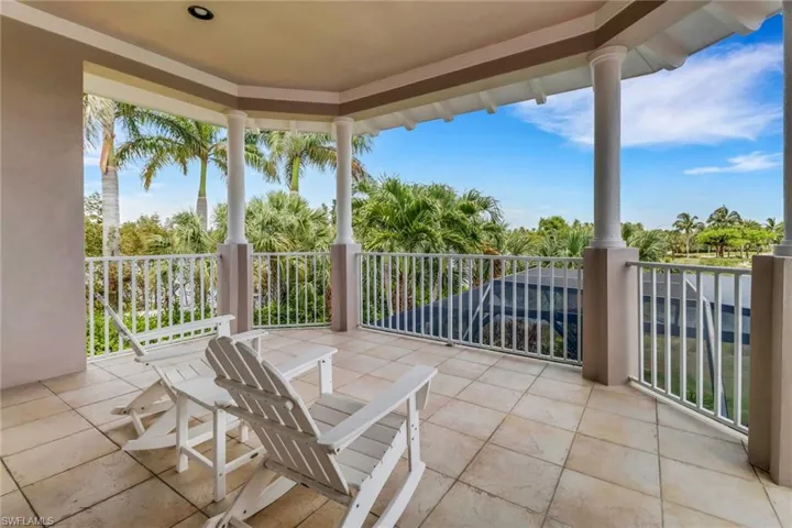 The large covered balcony if off the "Bonus" room/5th bedroom and overlooks the pool, backyard and waterfront.