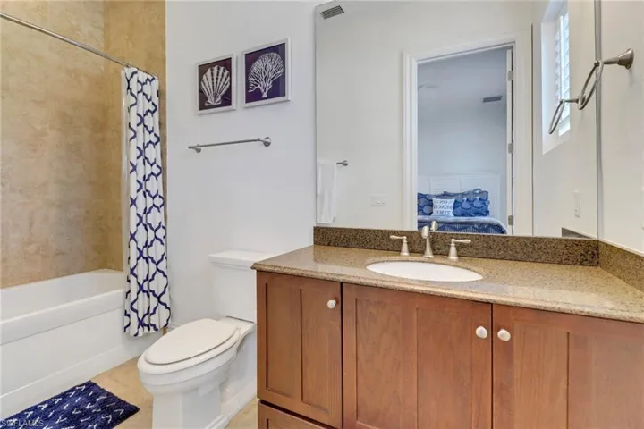 Bedroom #2's Bathroom with tub/shower combination and tile floor.