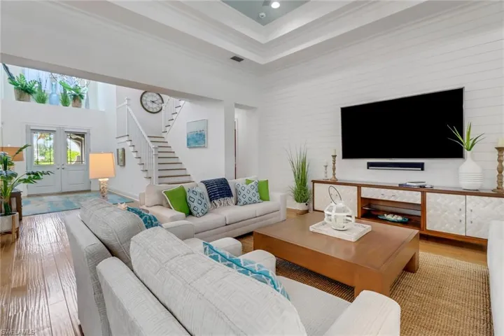 The living room and large foyer draw you to the wood stairway to the second floor.