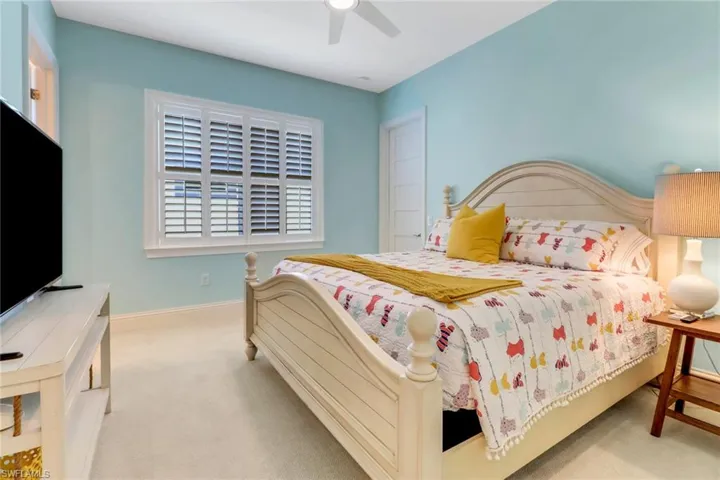Bedroom #3 with carpeted floor, full bath with tile floor and walk-in closet.