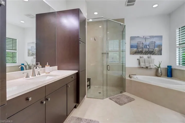 The primary bathroom has dual sinks, separate tub and shower and linen closet.