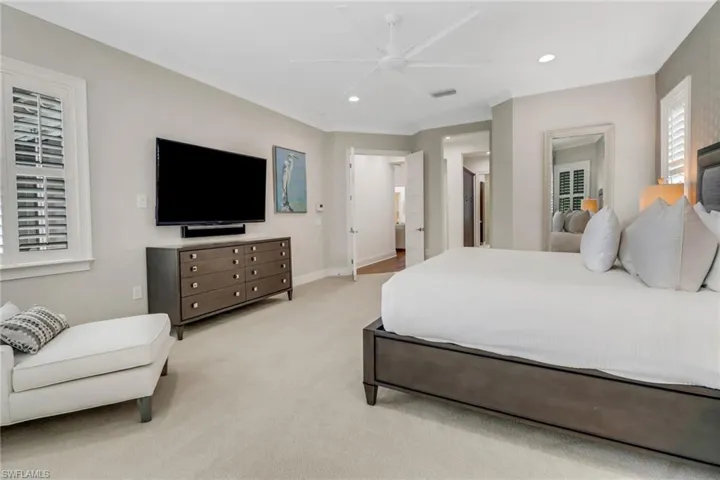 The primary bedroom facing the entry to primary closets and primary bathroom.