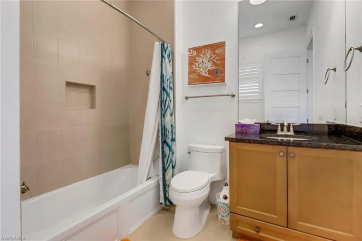 Bathroom #4 with tile floor and shower/tub combination.
