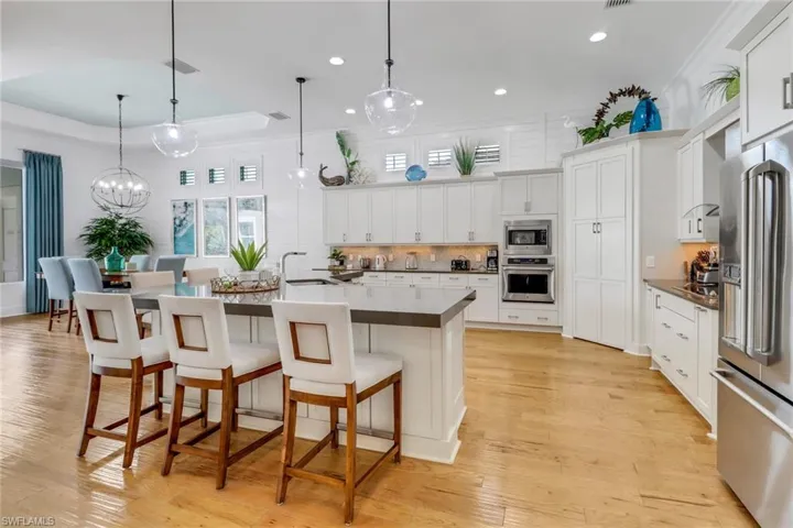 The large upscale gourmet kitchen with side bar and walk-in pantry.