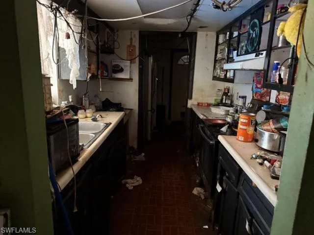 Kitchen featuring a sink, extractor fan, and light countertops