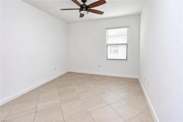 Neutral-toned tile flooring, recessed ceiling fan with integrated lighting, and horizontal window blinds
