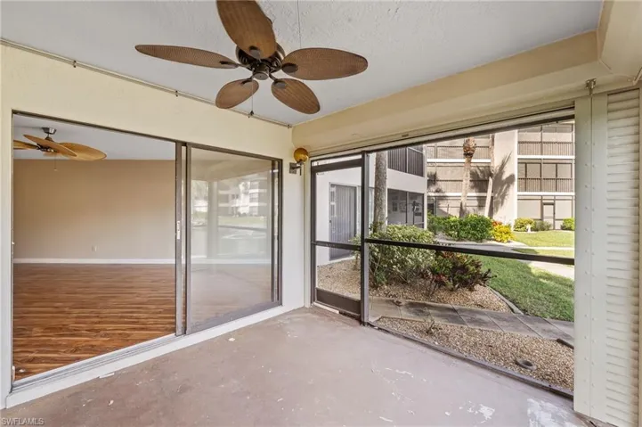 Unfurnished sunroom with ceiling fan