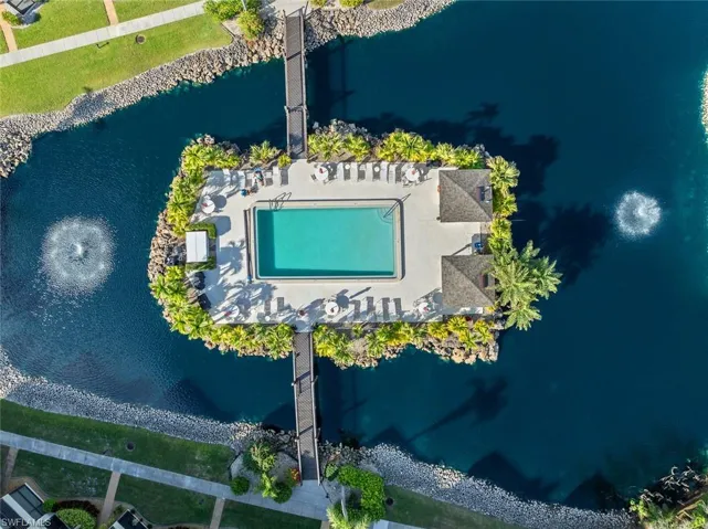 Drone / aerial view of a pool and a large body of water