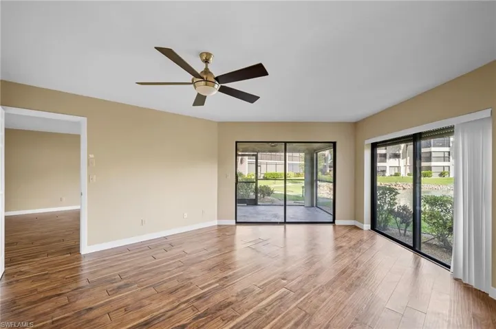 Empty room featuring wood finished floors and a ceiling fan