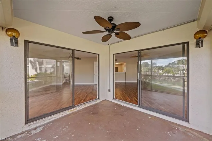 Unfurnished sunroom with ceiling fan