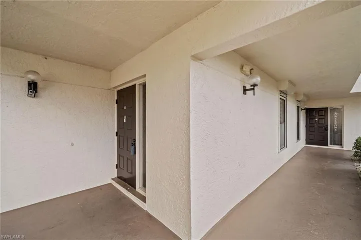 View of exterior entry with stucco siding