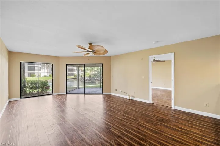 Spare room with dark wood finished floors and ceiling fan
