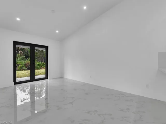 Unfurnished room featuring recessed lighting, marble finish floors, and baseboards
