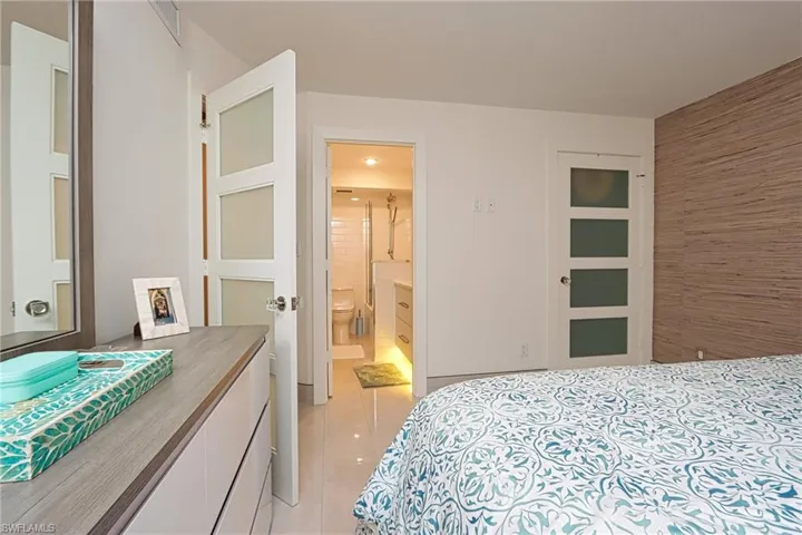 Tiled bedroom featuring ensuite bathroom