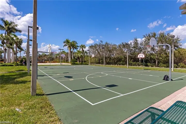 View of basketball court with community basketball court and a yard