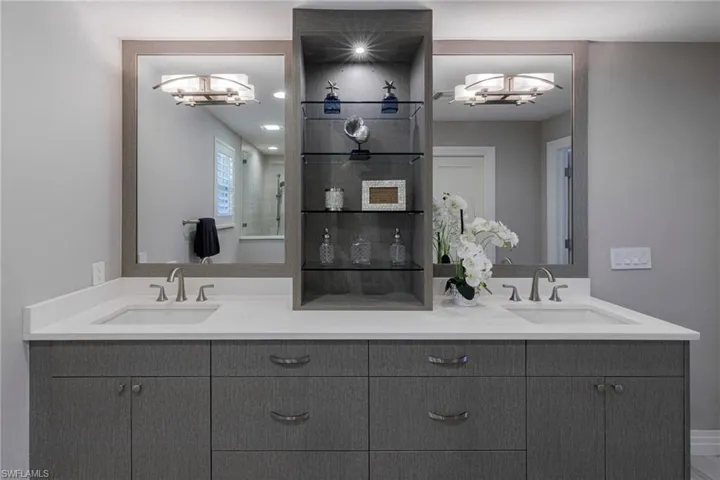 Bathroom featuring a notable chandelier and double vanity