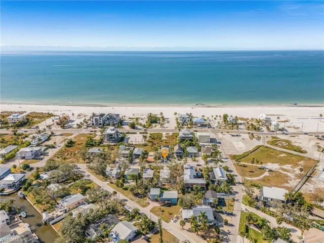Aerial perspective of suburban area featuring expansive coastline