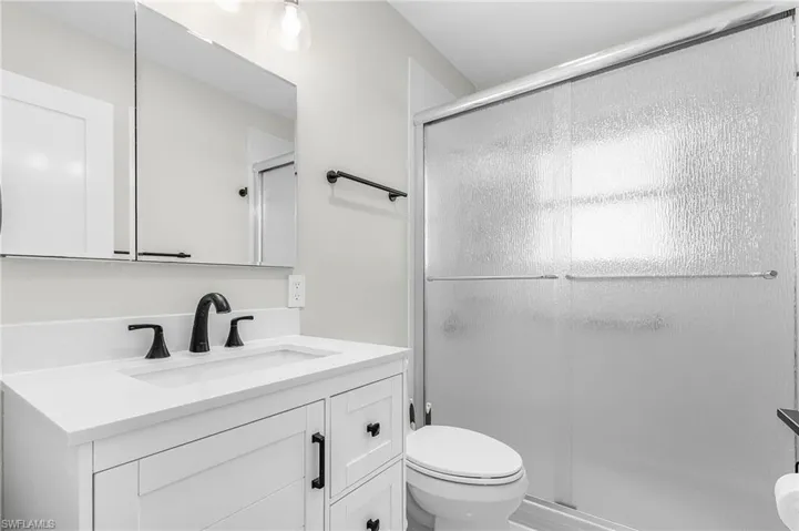 Bathroom featuring vanity and a shower stall