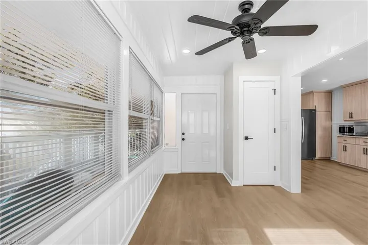 Corridor with light wood-style floors and recessed lighting