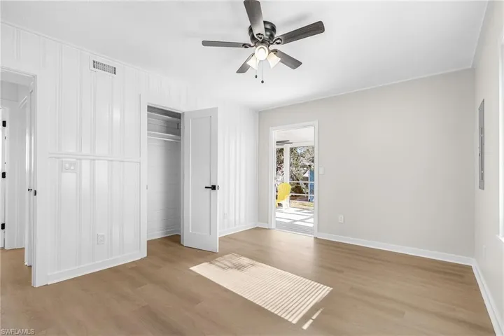 Unfurnished bedroom with a closet, light wood-style flooring, and ceiling fan