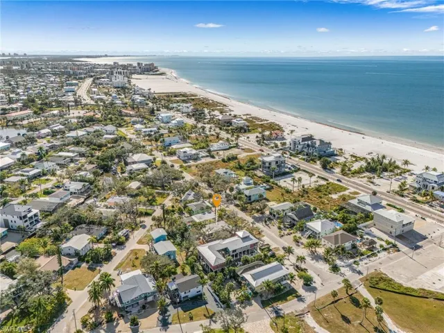 View of property location featuring nearby suburban area and expansive beach