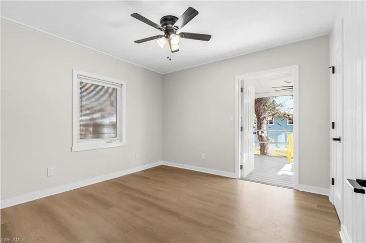 Empty room with ceiling fan and light wood-type flooring