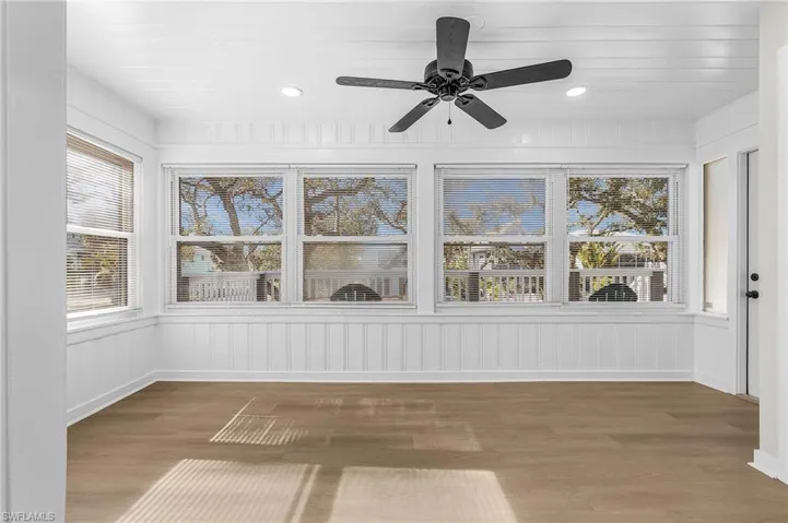 Unfurnished sunroom featuring wood finished floors, plenty of natural light, and recessed lighting