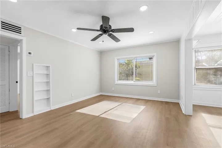 Unfurnished bedroom with a ceiling fan, light wood finished floors, recessed lighting, and ornamental molding