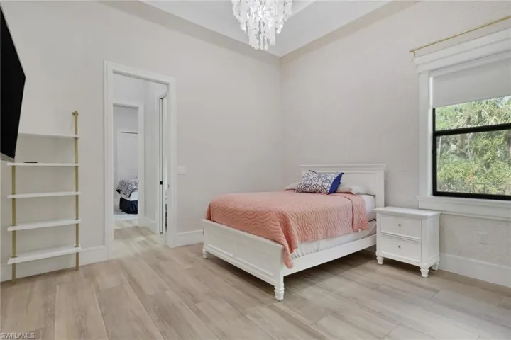 Bedroom with light wood-type flooring and a chandelier