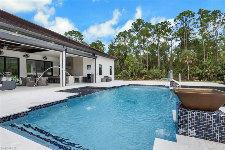 Outdoor pool featuring a patio and an outdoor kitchen