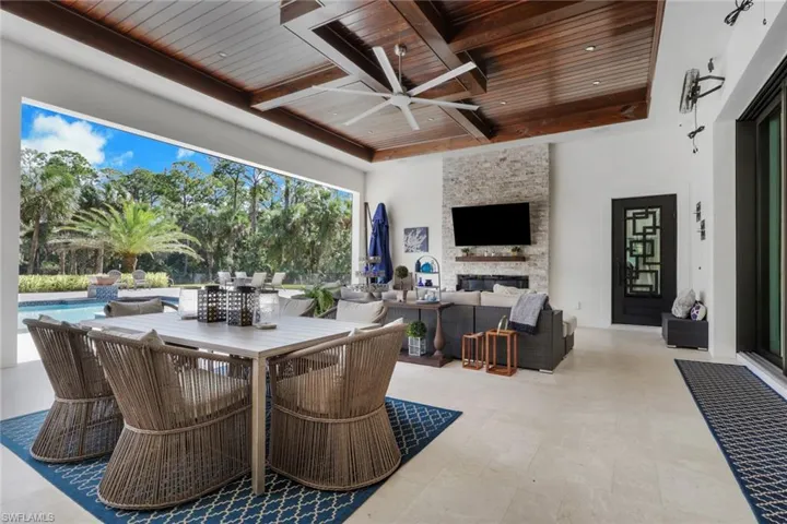 View of patio with outdoor lounge area, ceiling fan, outdoor dining space, and an outdoor pool