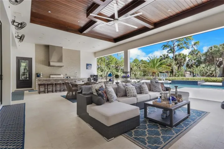 View of patio featuring a ceiling fan, an outdoor pool, an outdoor hangout area, and area for grilling