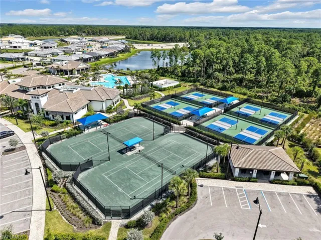Community amenities featuring multiple tennis courts, pickleball courts, a large swimming pool, a clubhouse, and a lake