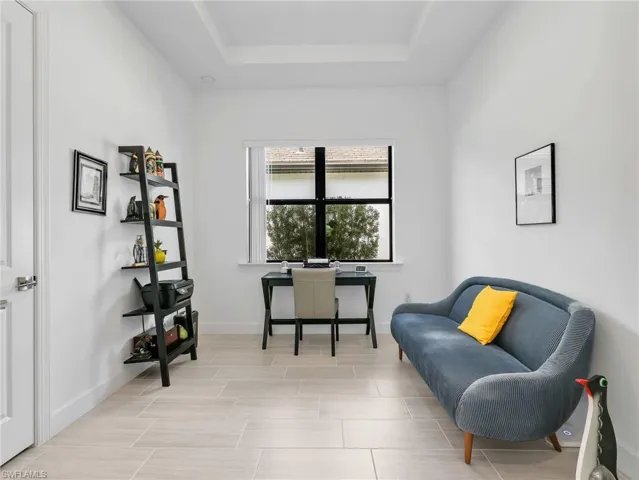 3rd Bedroom with closet, Recessed lighting, tray ceiling, large window, and light-toned tile flooring