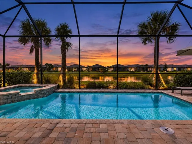 Screened-in outdoor living space with a pool and integrated spa