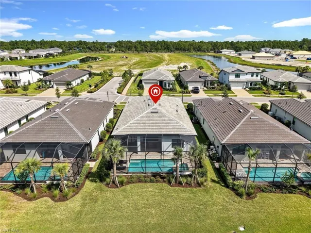 Screened-in pool deck, landscaped grounds, tile roofing, and an adjacent water feature