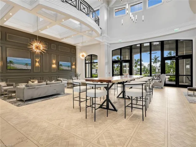 Clubhouse Two-story interior with coffered ceilings, decorative wall paneling, and large arched windows